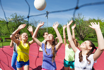 Piger spiller volleyball.